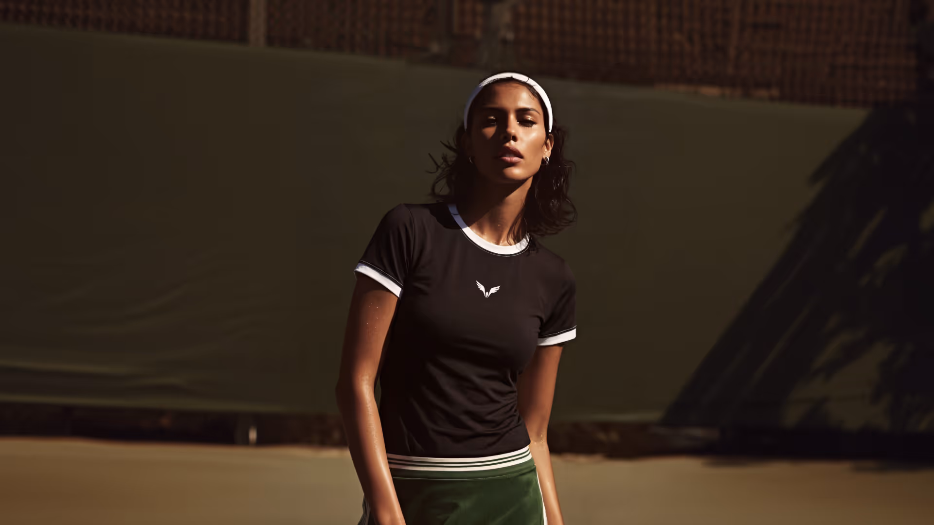 Close-up side profile of a person with short blonde hair and large round glasses against an orange background.
